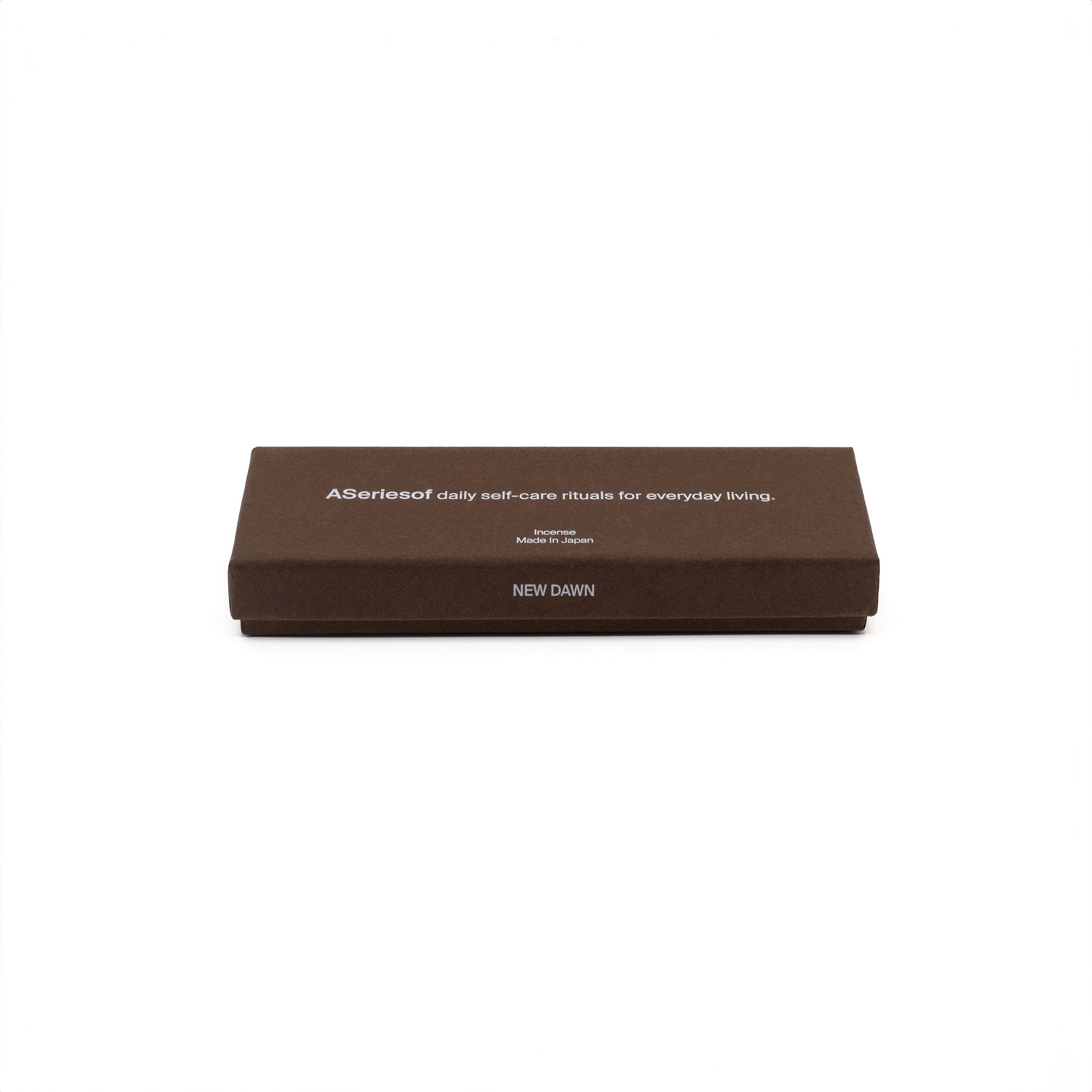 ASeriesof incense sticks bamboo-less made in Japan in a brown box, text "a series of daily self-care rituals for everyday living." and "new dawn" fragrance name on the box.